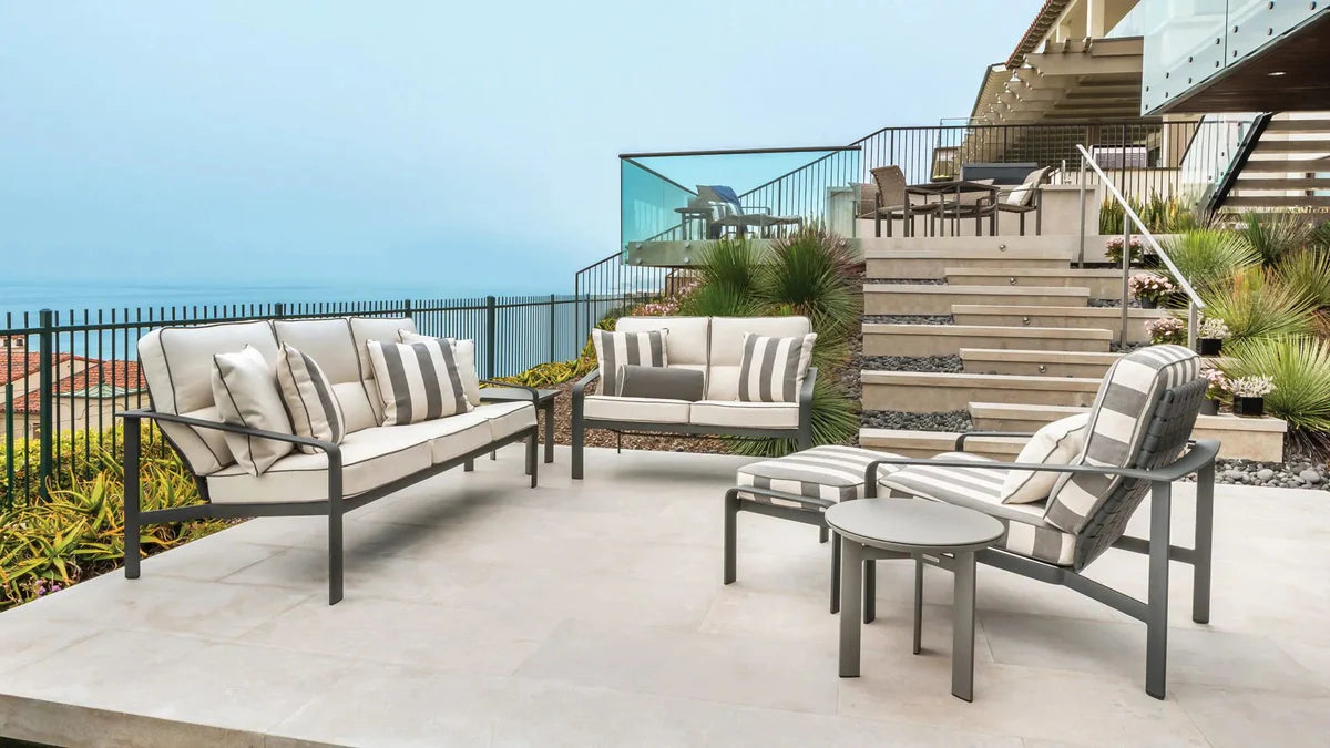 Patio furniture seating area on patio overlooking ocean